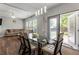 Bright dining room with a glass table, modern lighting, and sliding door access to backyard at 5830 Sterling Ct, Cumming, GA 30040