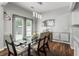 Dining room featuring glass table, modern light fixtures, and patio access at 5830 Sterling Ct, Cumming, GA 30040