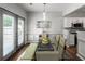 Dining area with glass table, stylish lighting, and backyard access at 5830 Sterling Ct, Cumming, GA 30040