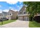 Well-maintained two-story home showcasing a two-car garage, lush lawn, and established landscaping in a suburban neighborhood at 5830 Sterling Ct, Cumming, GA 30040