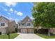 Two-story home featuring gray siding, a two-car garage, and a landscaped front yard with a mature shade tree at 5830 Sterling Ct, Cumming, GA 30040