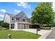 Charming two-story home with a well-manicured lawn, two-car garage, and a beautiful mature tree in the front yard at 5830 Sterling Ct, Cumming, GA 30040