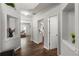 Bright hallway with hardwood floors and decorative shelving leading to open living spaces, including a kitchen view at 5830 Sterling Ct, Cumming, GA 30040