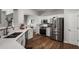 Modern kitchen with stainless steel appliances, quartz countertops, and hardwood floors at 5830 Sterling Ct, Cumming, GA 30040