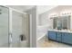 En-suite bathroom features a glass shower door, soaking tub, and double sink vanity at 5830 Sterling Ct, Cumming, GA 30040