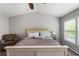 Spacious main bedroom with carpet, ceiling fan, sitting chair and plenty of natural light at 5830 Sterling Ct, Cumming, GA 30040