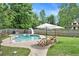Backyard featuring in-ground pool, slide, lounge chairs, and a surrounding green lawn at 10 Callaway Ct, Hiram, GA 30141