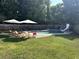 Inviting backyard pool area with a slide and shaded lounge chairs for relaxation at 10 Callaway Ct, Hiram, GA 30141