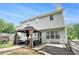 A house backyard with a patio set under a gazebo, with lush grass, fence and a grey-sided house at 10 Callaway Ct, Hiram, GA 30141