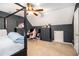 Angled bedroom with a four-poster bed and black painted walls, pink accents at 10 Callaway Ct, Hiram, GA 30141