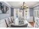 Elegant dining room with a glass table, tufted chairs, and statement chandelier at 10 Callaway Ct, Hiram, GA 30141