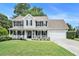 Charming two-story home with a welcoming front porch, attached garage and well-maintained lawn at 10 Callaway Ct, Hiram, GA 30141