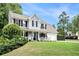 Beautiful two-story house with a charming front porch, a well-manicured lawn and mature trees at 10 Callaway Ct, Hiram, GA 30141