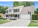 Two-story house featuring a covered front porch and an attached garage with basketball hoop at 10 Callaway Ct, Hiram, GA 30141