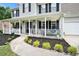 Inviting front porch featuring a white railing, black shutters and a manicured front lawn at 10 Callaway Ct, Hiram, GA 30141