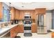 Bright kitchen featuring stainless steel appliances, light countertops, wooden cabinets and tile flooring at 10 Callaway Ct, Hiram, GA 30141