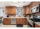 Bright kitchen featuring stainless steel appliances, light countertops, wooden cabinets, and tile flooring at 10 Callaway Ct, Hiram, GA 30141
