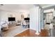 Cozy living room with hardwood floors, decorative columns, and an open floor plan at 10 Callaway Ct, Hiram, GA 30141