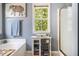 Well lit bathroom featuring soaking tub with caddy, storage cabinet, and shower at 10 Callaway Ct, Hiram, GA 30141