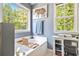 Bright bathroom featuring soaking tub with caddy, storage cabinet, and large windows at 10 Callaway Ct, Hiram, GA 30141