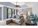 Main bedroom with tray ceiling, sitting area, and large windows overlooking exterior greenery at 10 Callaway Ct, Hiram, GA 30141