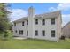 Expansive backyard with lush green grass, patio, and bright exterior of home with multi-pane windows at 1024 Odelle Cir, Mcdonough, GA 30253