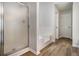 Bright bathroom features a glass enclosed shower, a separate tub and wood look floors at 1024 Odelle Cir, Mcdonough, GA 30253