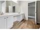 Well-lit bathroom with double sinks, white cabinets, and vanity area adjacent to bedroom at 1024 Odelle Cir, Mcdonough, GA 30253