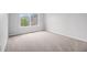 Cozy bedroom with natural light from the window and plush neutral carpet at 1024 Odelle Cir, Mcdonough, GA 30253