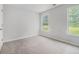 Bedroom with neutral carpet, and views of the yard through its two windows at 1024 Odelle Cir, Mcdonough, GA 30253