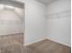 Walk-in closet featuring shelving and neutral carpeting at 1024 Odelle Cir, Mcdonough, GA 30253