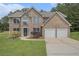 Charming two-story brick home with a well-manicured lawn and an attached two-car garage at 1024 Odelle Cir, Mcdonough, GA 30253