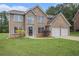 Charming two-story brick home with a well-manicured lawn and an attached two-car garage at 1024 Odelle Cir, Mcdonough, GA 30253