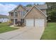 Charming two-story brick home with a well-manicured lawn and an attached two-car garage at 1024 Odelle Cir, Mcdonough, GA 30253