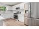 Modern kitchen featuring stainless steel appliances, white cabinets, and light countertops at 1024 Odelle Cir, Mcdonough, GA 30253