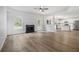 Bright living room with fireplace, wood floors, and an open view into the modern kitchen at 1024 Odelle Cir, Mcdonough, GA 30253