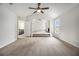 Open-concept living room features plush carpet, high vaulted ceiling, fireplace, and bright window at 1024 Odelle Cir, Mcdonough, GA 30253