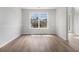 Bright living room features hardwood floors and a large window with views of the surrounding neighborhood at 1024 Odelle Cir, Mcdonough, GA 30253
