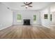 Bright living room with fireplace, wood floors, and an open view into the backyard at 1024 Odelle Cir, Mcdonough, GA 30253
