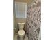 Bathroom with white toilet, window, and decorative shower curtain at 105 Lena Cir, Stockbridge, GA 30281