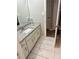 Bathroom showcasing white vanity with granite countertop and sleek tile floors at 105 Lena Cir, Stockbridge, GA 30281