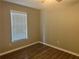 Bedroom with dark wood-look floors, neutral paint, and a window at 105 Lena Cir, Stockbridge, GA 30281