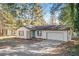 Inviting single-story home with a well-manicured lawn and a paved driveway leading to an attached garage at 105 Lena Cir, Stockbridge, GA 30281