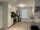 Kitchen featuring stainless steel appliances, wood-look floors and painted white cabinets at 105 Lena Cir, Stockbridge, GA 30281