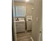 Functional laundry room with a washer, dryer, and ironing board, making laundry tasks more efficient and organized at 105 Lena Cir, Stockbridge, GA 30281