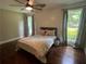 Bedroom with hard wood floors, ceiling fan and two large windows overlooking the yard at 284 Harris Loop, Dallas, GA 30157