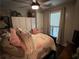 Bedroom features hardwood floors, a ceiling fan, and a comfortable bed at 284 Harris Loop, Dallas, GA 30157