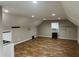 Open concept bonus room with ample lighting, offering versatility for various activities at 284 Harris Loop, Dallas, GA 30157