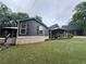 Beautiful home with dark siding, brick foundation, and a detached two-car garage with upstairs at 284 Harris Loop, Dallas, GA 30157