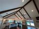 Open-concept living area featuring exposed beams, hardwood floors, and a modern kitchen at 284 Harris Loop, Dallas, GA 30157